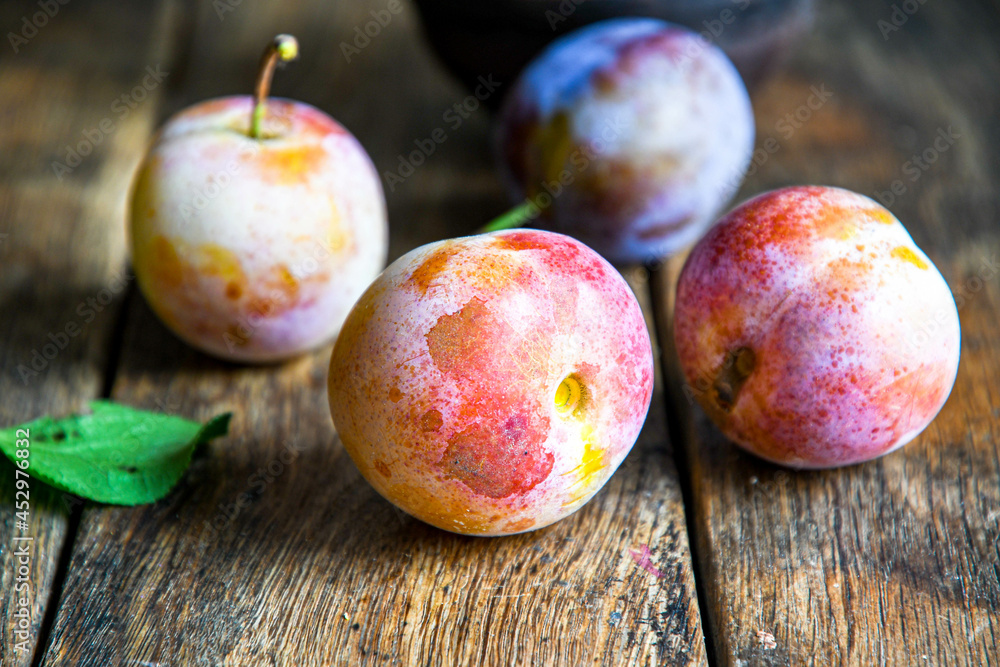 Home harvest fresh plums on a wooden table. Home harvest fresh plums on a wooden table.