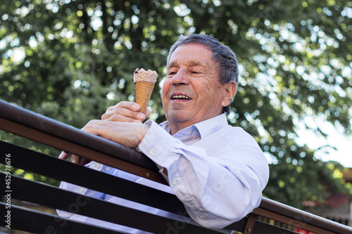 Happy senior Man eating ice cream 