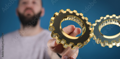 Cyborg hand holding a gear ...