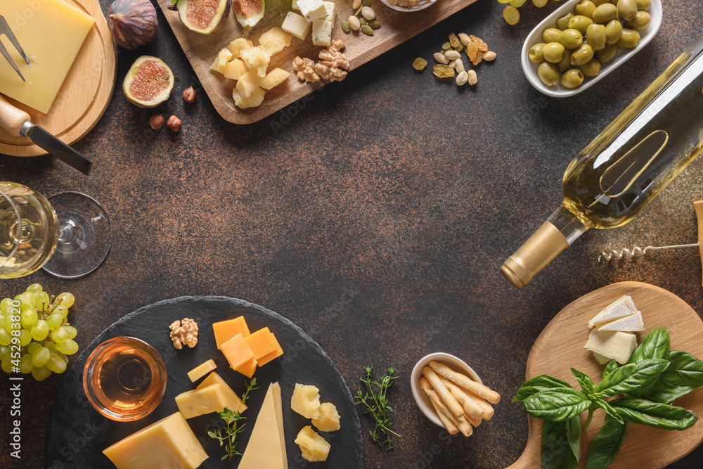 Cheese platter with grapes, nuts, figs on a brown background. Top view. Copy space. Appetizer for festive party. Cheese platter with grapes, nuts, figs on a brown background. Top view. Copy space. Appetizer for festive party.