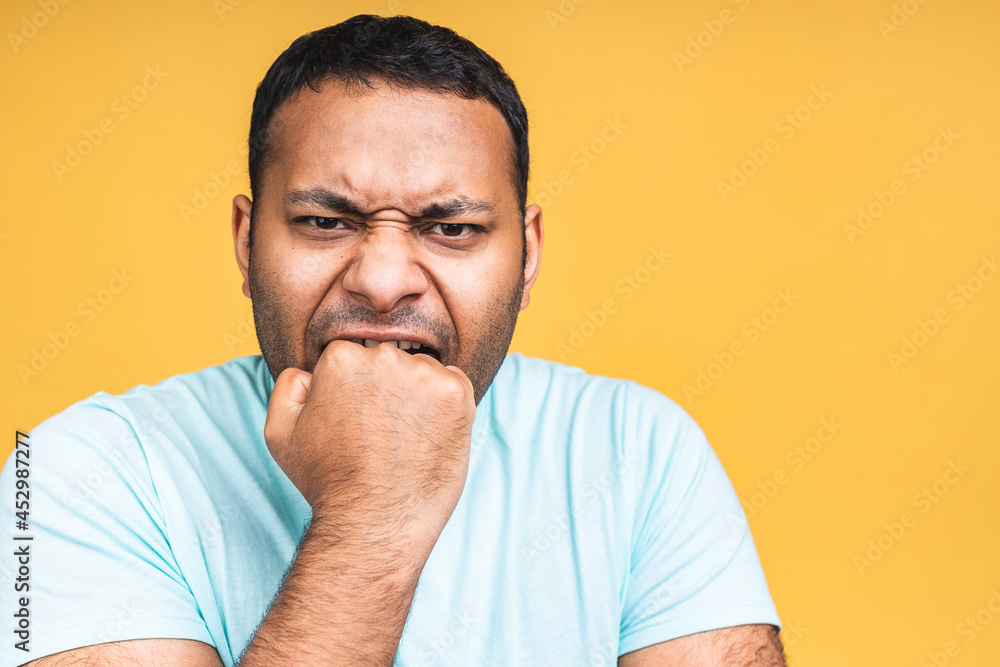 Furious enraged angry crazy african american indian black man with grumpy grimace on his face, with mouth opened in shout, ready to argue and swear, show strength, isolated over yellow background. Furious enraged angry crazy african american indian black man with grumpy grimace on his face, with mouth opened in shout, ready to argue and swear, show strength, isolated over yellow background.