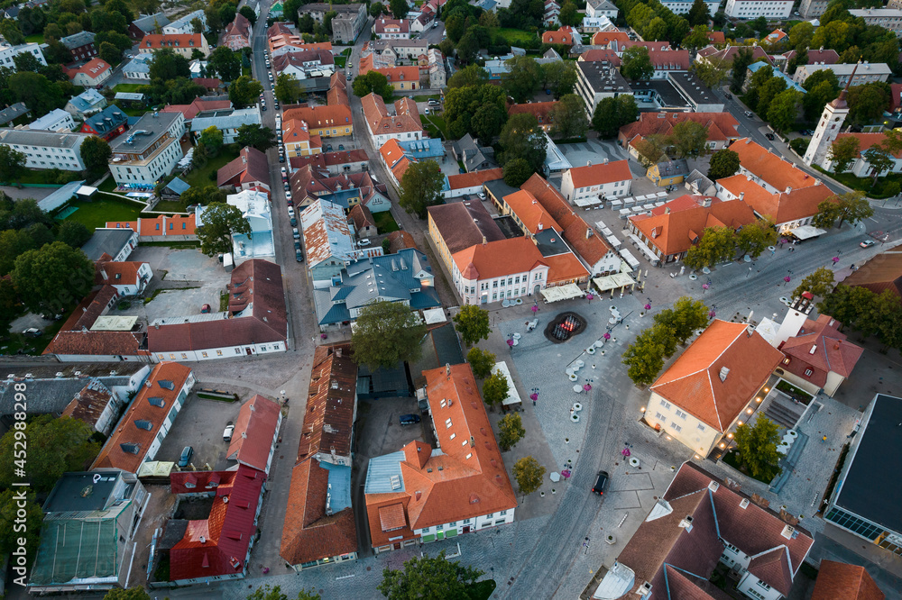 Naklejka premium An aerial view of Kuressaare city in Saaremaa island during late August evening. Top drone view of a city by Baltic sea.