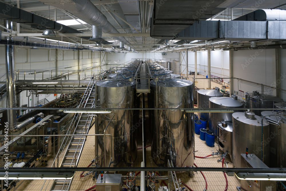 Modern winery production line. Storage vats and bottling equipment