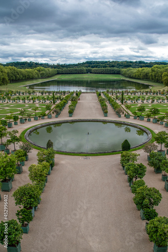 A view of one of the garden areas of the Palace of Versailles near Paris, France, on a cloudy and overcast day.