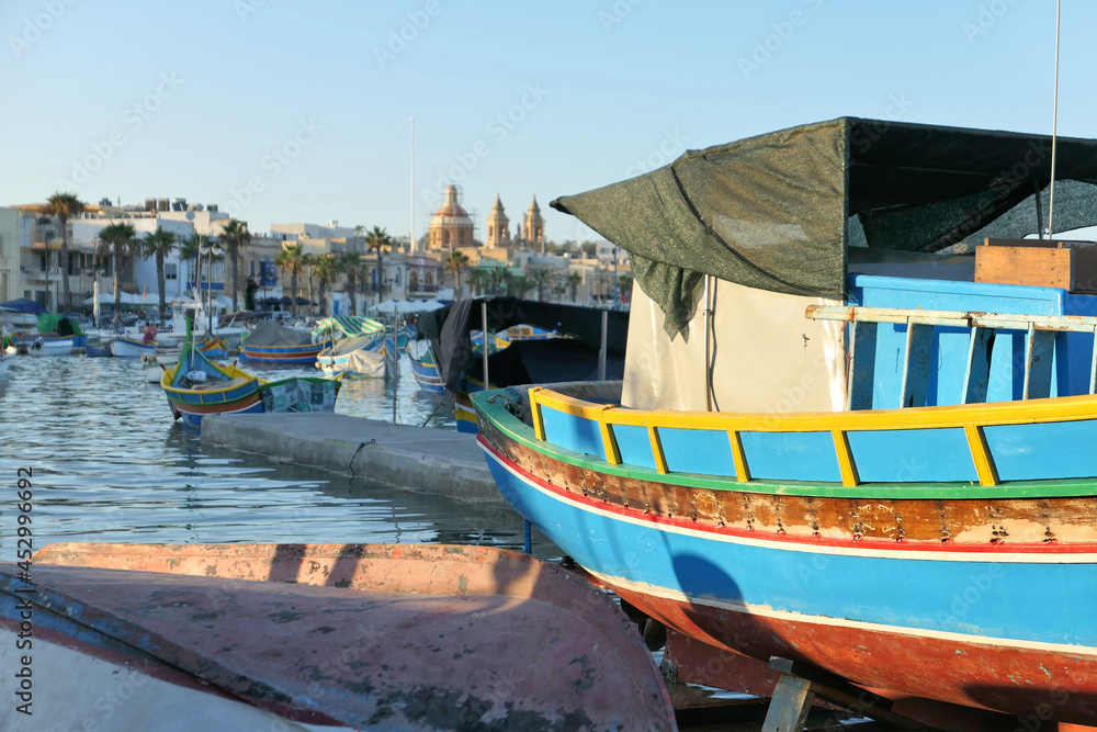 Colorful fishing luzzu boats in Malta harbor in Marsaxlokk