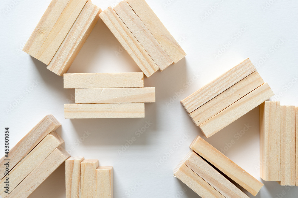 close up of loosely arranged wooden tiles on a white background close up of loosely arranged wooden tiles on a white background