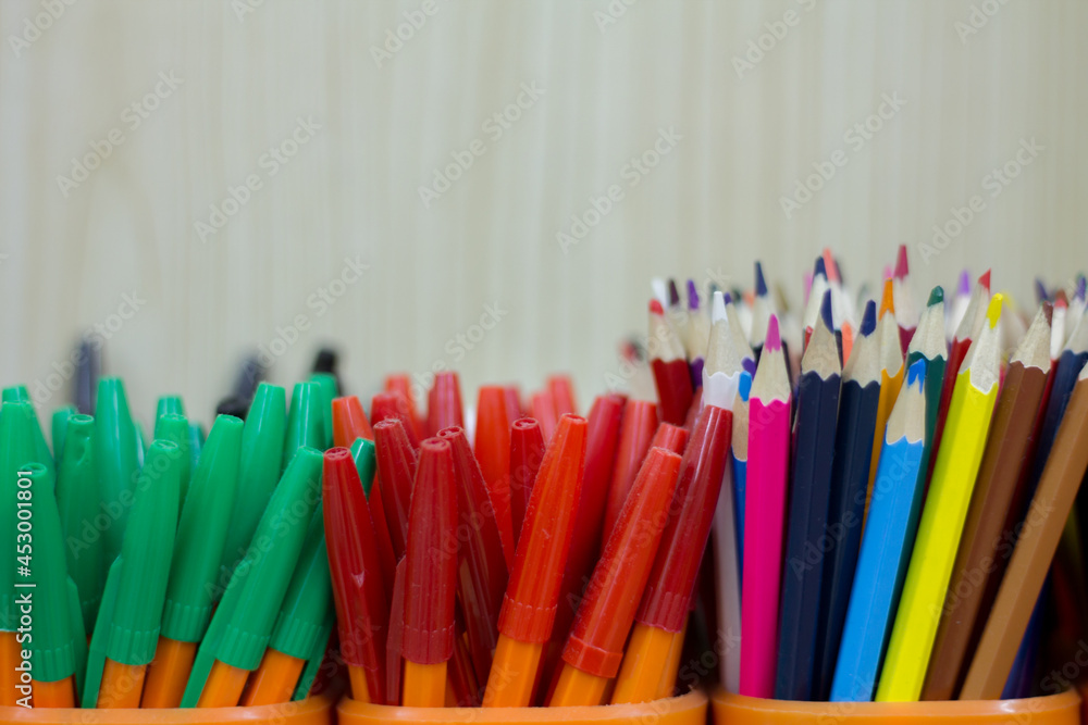 Fototapeta premium pencils and pens in cups. office supplies close up.