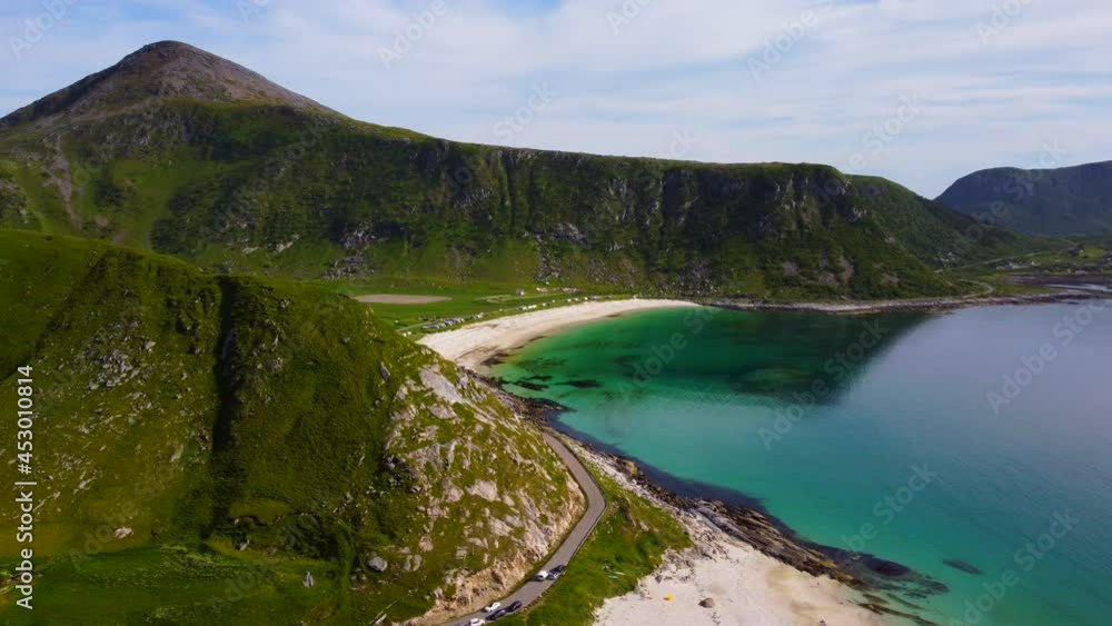 White sand beach surrounded by beautiful grass mountains and turquoise sea White sand beach surrounded by beautiful grass mountains and turquoise sea
