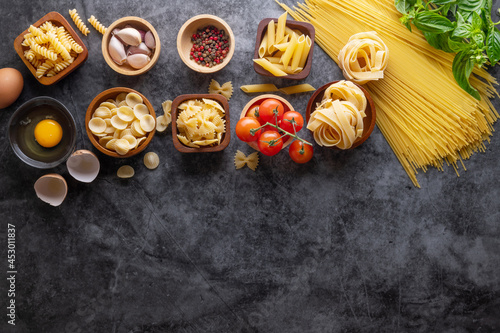 Mixed dried pasta selection on stone background