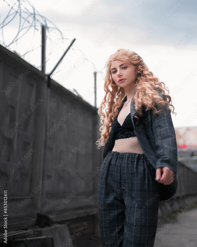 Fototapeta premium Young blonde girl on the street. Beauty and youth