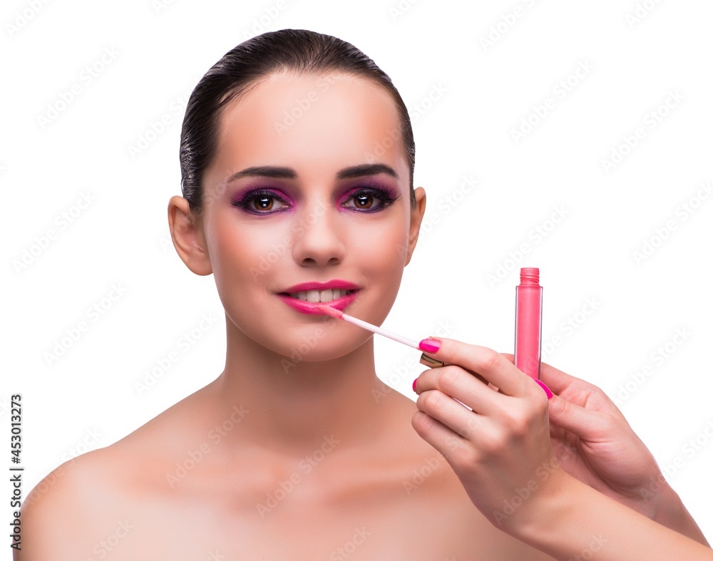Woman applying lipstick isolated on white Woman applying lipstick isolated on white