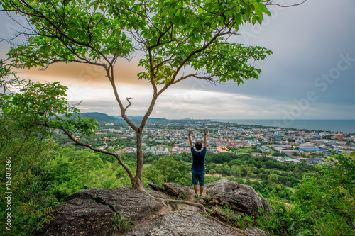 panoramic background of high mountain scenery, overlooking the atmosphere of the sea, trees and wind blowing in a cool blur, spontaneous beauty © bangprik
