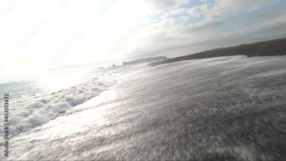 FPV low altitude proximity flying over ocean waves breaking at the black sand beach in Iceland FPV low altitude proximity flying over ocean waves breaking at the black sand beach in Iceland