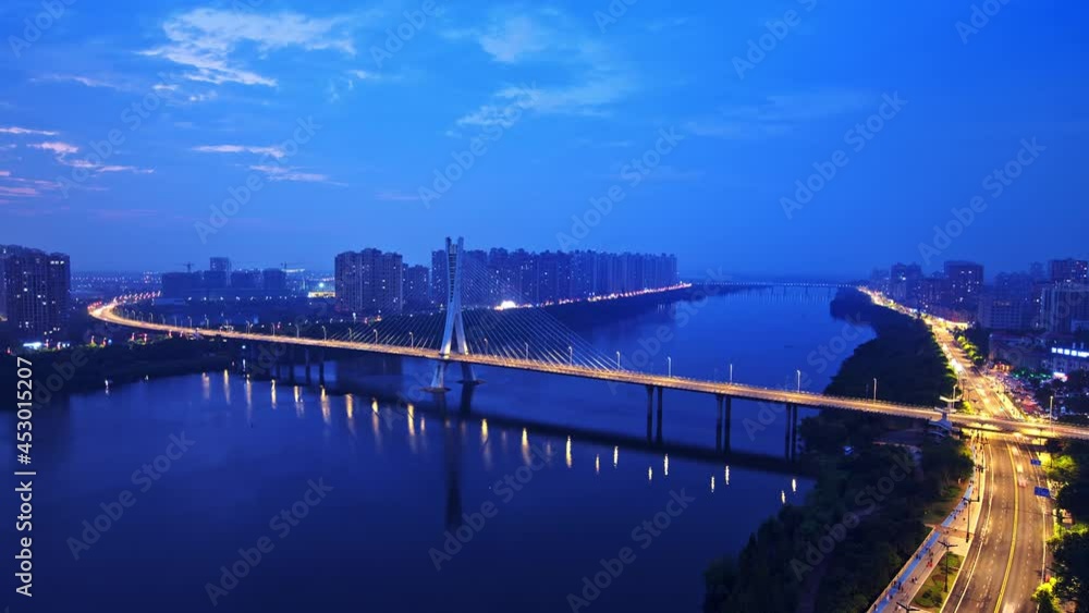 Time-lapse shot of cross-river bridge, heavy traffic and high-rise buildings at night in the city Time-lapse shot of cross-river bridge, heavy traffic and high-rise buildings at night in the city