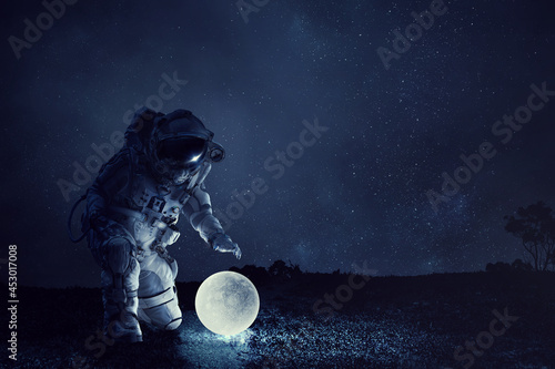 Fototapeta Naklejka Na Ścianę i Meble -  Astronaut and moon . Mixed media . Mixed media