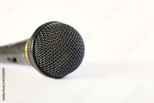 Close-up old microphone. Detail of used microphone head on white background with copy space. Selective focus