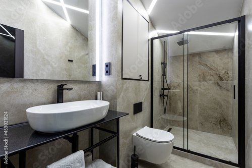 Bathroom in a traditional style with brown and gray walls.Minimalist shower room with hotel sauna
