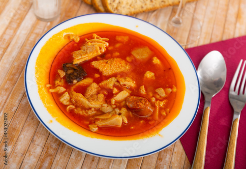 Callos Madrilenos served on table with bread and serving pieces