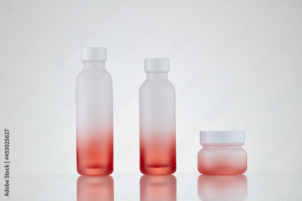 Set cosmetic bottle with gradient design on white background. Cosmetic cream containers and cosmetic bottles on white background. Blank label for design Set cosmetic bottle with gradient design on white background. Cosmetic cream containers and cosmetic bottles on white background. Blank label for design