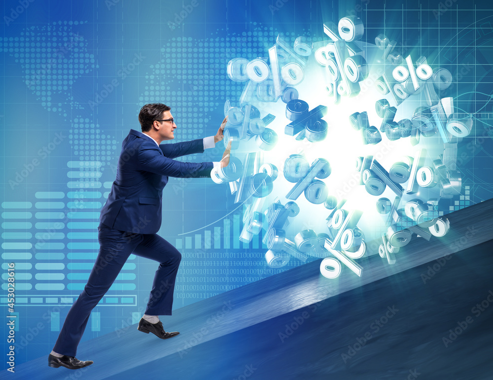 Businessman pushing away high interest rates Businessman pushing away high interest rates
