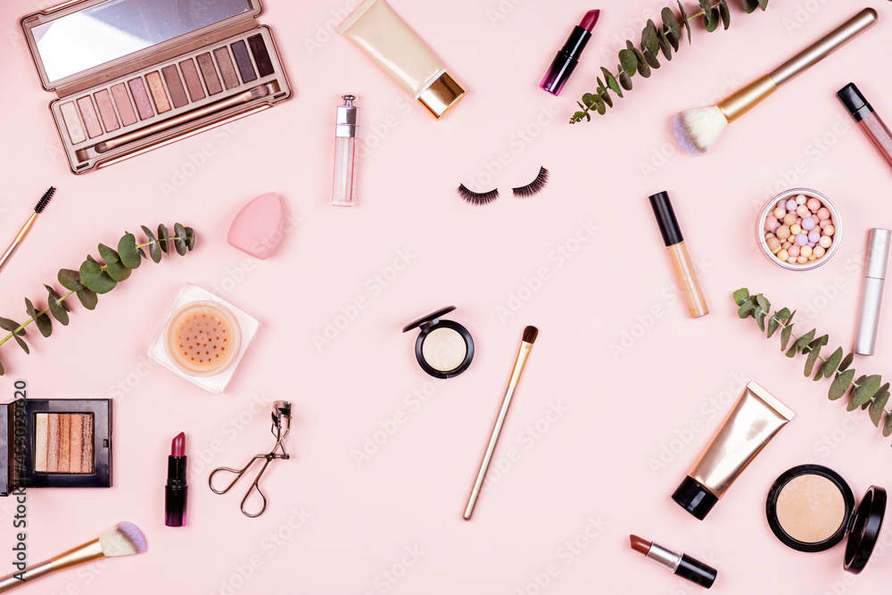 Flat lay of professional Cosmetics set on pastel pink background. Female facial beauty care products Flat lay of professional Cosmetics set on pastel pink background. Female facial beauty care products