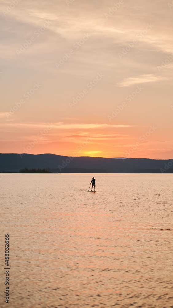 Sportsman paddling the standing board