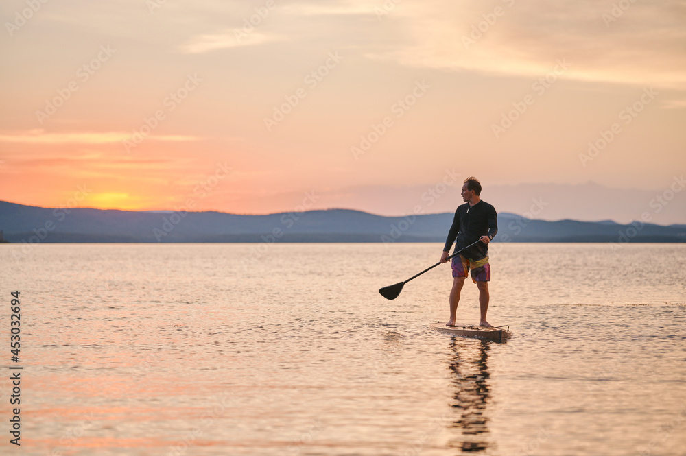 Sportsman paddling the standing board