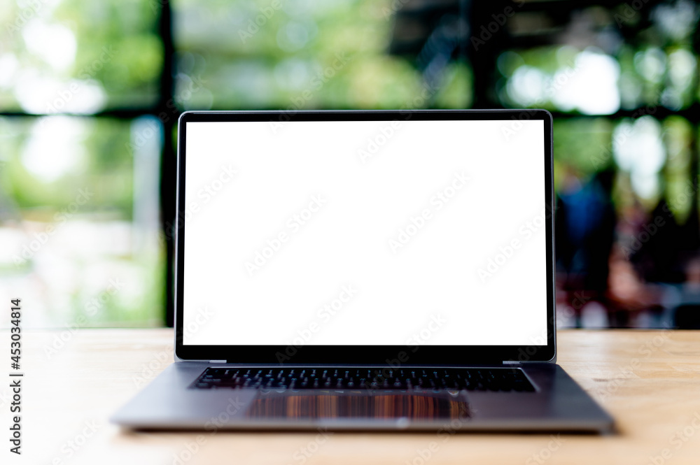 Laptop with blank screen on desk, in office, empty space. concept of working with laptop and working online online communication Laptop with blank screen on desk, in office, empty space. concept of working with laptop and working online online communication