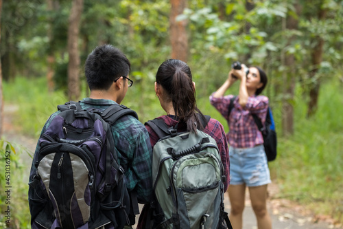 Group teens asian travel with backpack at spruce forest looking map the route go to destinations, Concept Travel