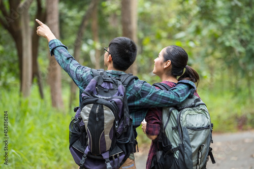 Portrait of couple teens asian backpacker a travel and relaxing in the forest, Concept of relax and travel