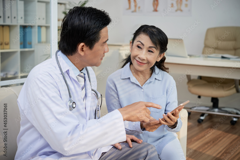 Obraz premium Doctor Showing Telemedicine App to Patient