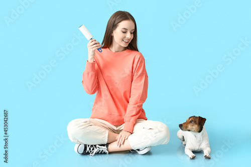 Young woman with lint rolle...