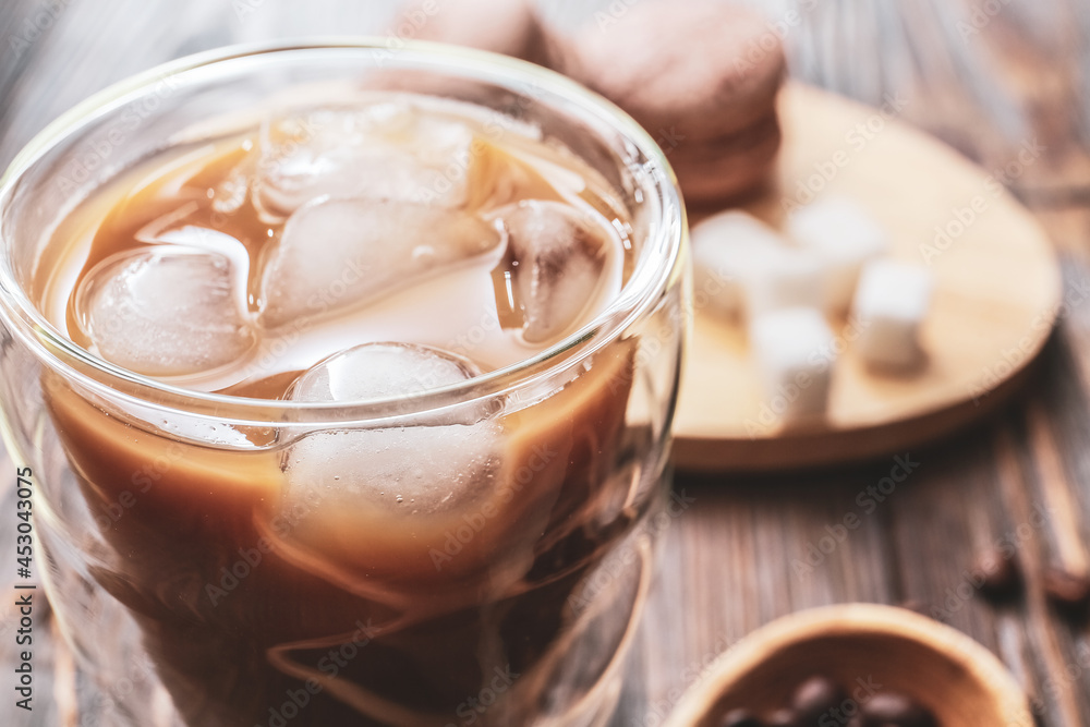 Glass of tasty iced coffee on table, closeup Glass of tasty iced coffee on table, closeup