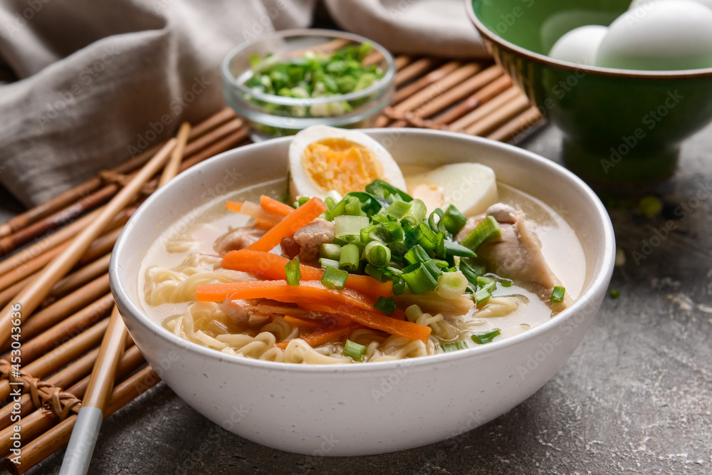 Tasty Chinese soup with chicken in bowl on grunge background Tasty Chinese soup with chicken in bowl on grunge background