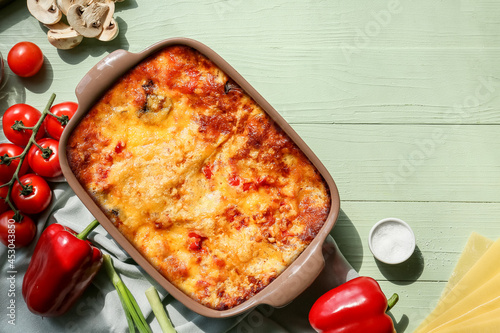 Composition with tasty vegetable lasagna on color wooden background