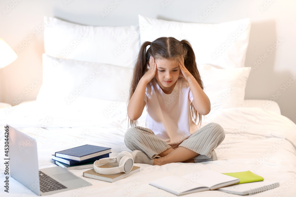 Tired little girl studying at home Tired little girl studying at home