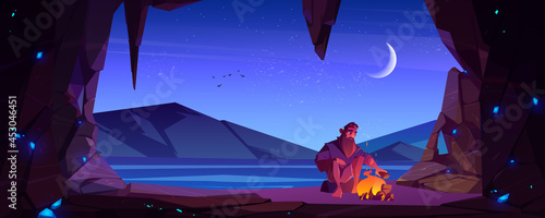 Alone castaway man in cave on uninhabited island with bonfire at night. Shipwrecked sad survivor bask by the fire on sea shore at stone cavern entrance after shipwreck Cartoon vector illustration