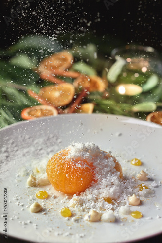 Caramelized tangerine with coconut flakes on background with Christmas decorations
