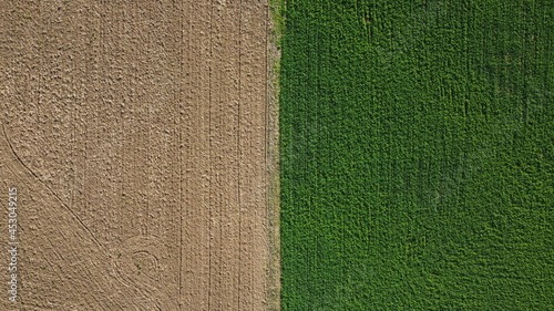 top down image of the seperation and contrast between a harvested field and a plowed field in rural agricultural farmland, Australia