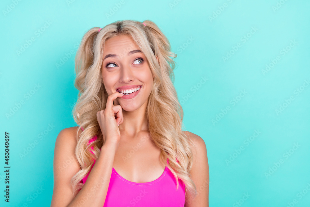 Portrait of attractive minded cheerful wavy-haired girl thinking copy space isolated over bright teal turquoise color background