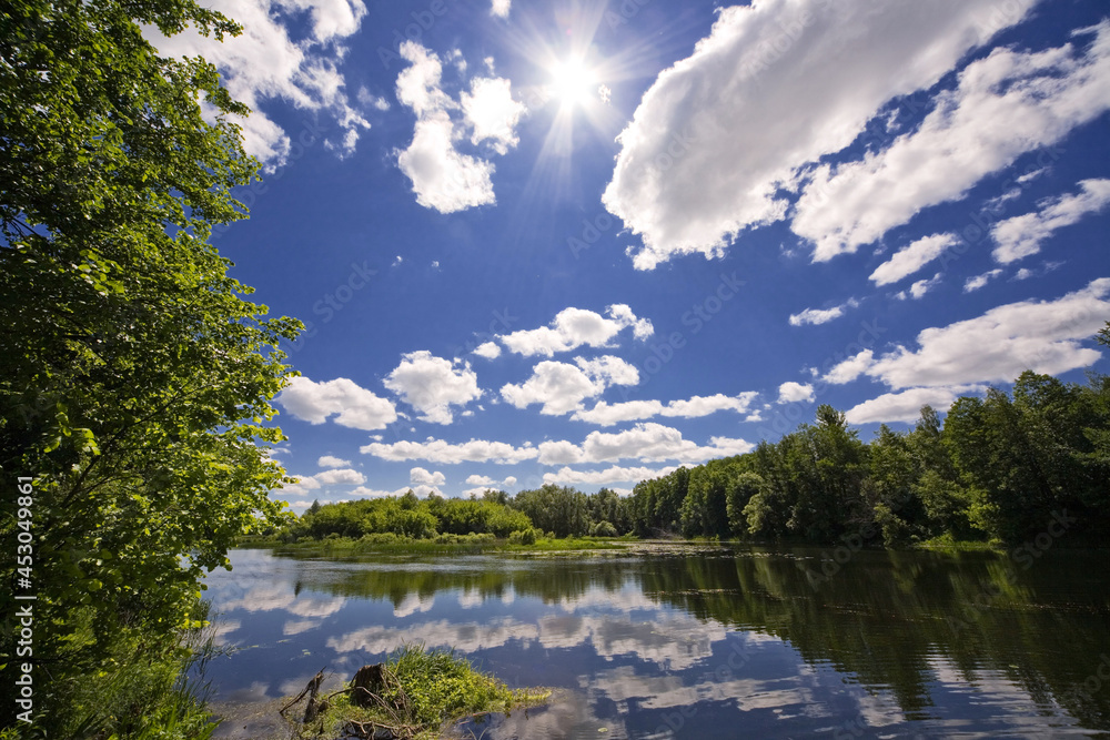 Summer landscape, nature in August, river, forest and beautiful clouds