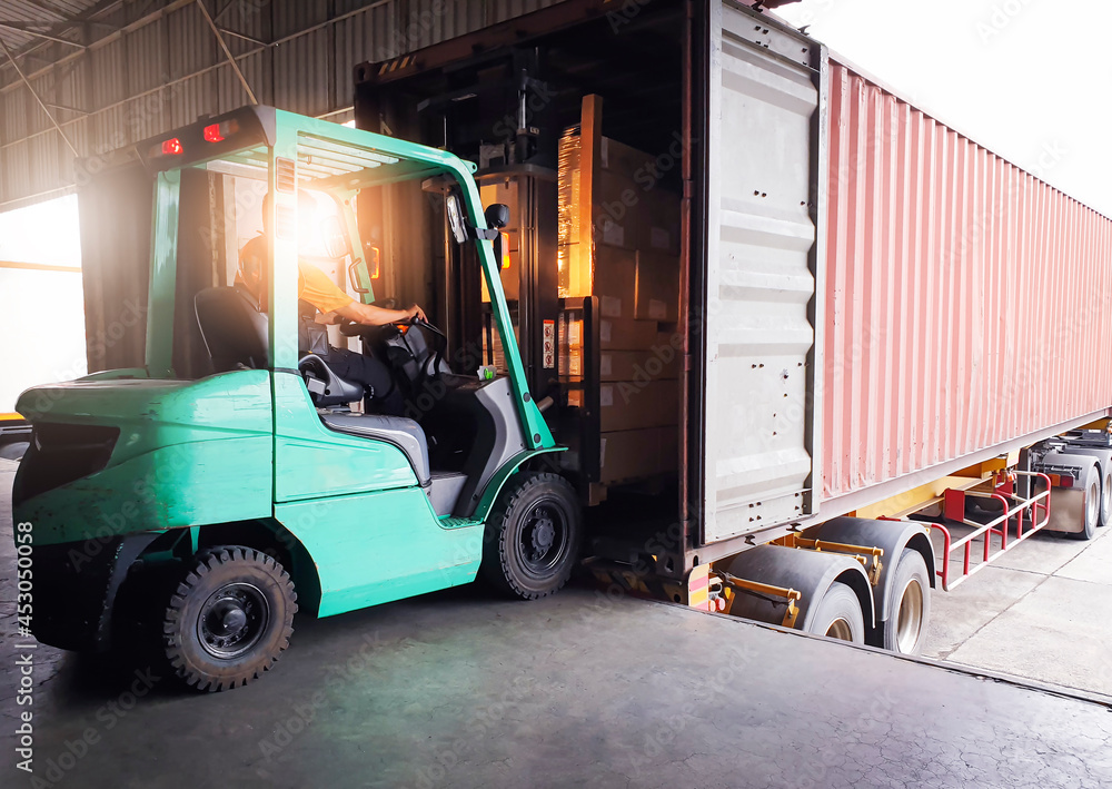Forklift Tractor Loading Package Boxes into Cargo Container at Dock Warehouse. Delivery Service. Shipping Warehouse Logistics. Cargo Shipment. Freight Truck Transportation.	
