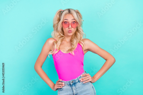 Portrait of attractive amazed funky wavy-haired girl posing oops pout lips isolated over vivid teal turquoise color background photo