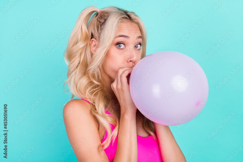 Profile side photo of young girl blow air balloons decor party birthday isolated over teal color background Profile side photo of young girl blow air balloons decor party birthday isolated over teal color background