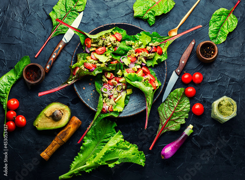 Healthy vegetable salad in chard leaves photo