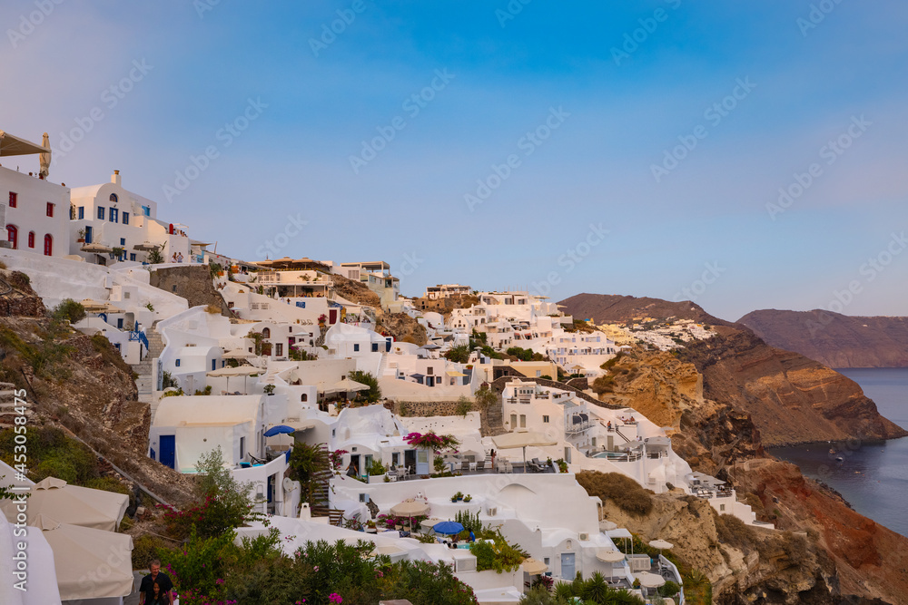 Tourists return to the cliff side accommodation in the village of Oia on the Greek island of Santorini