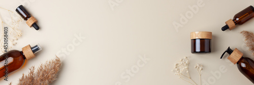 Photography Cosmetic skin care products with flowers and pampas on pastel beige background