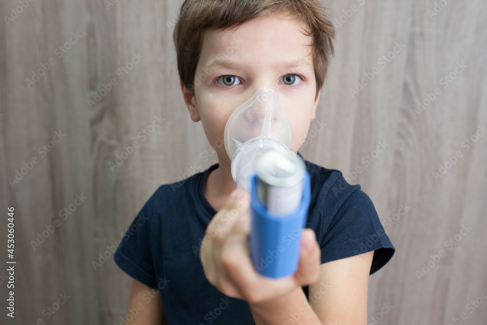 Child boy using medical spray for breath