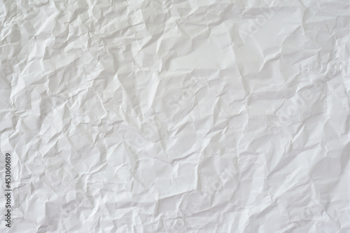 Crumpled white paper as background.
