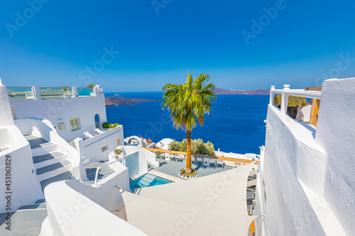 Perfect view in Santorini with white architecture luxury infinity pool over cruise ships and blue sea. Luxury summer vacation and holiday concept. Amazing landscape caldera view